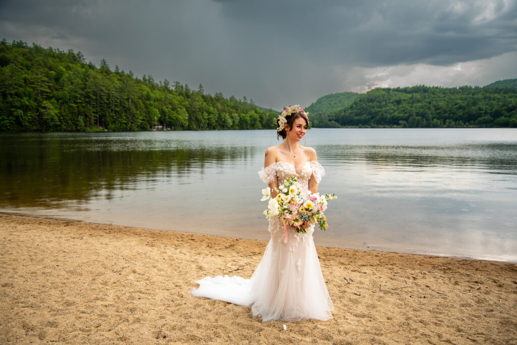 The Bride standing in front of the lake on the sweetest wedding day