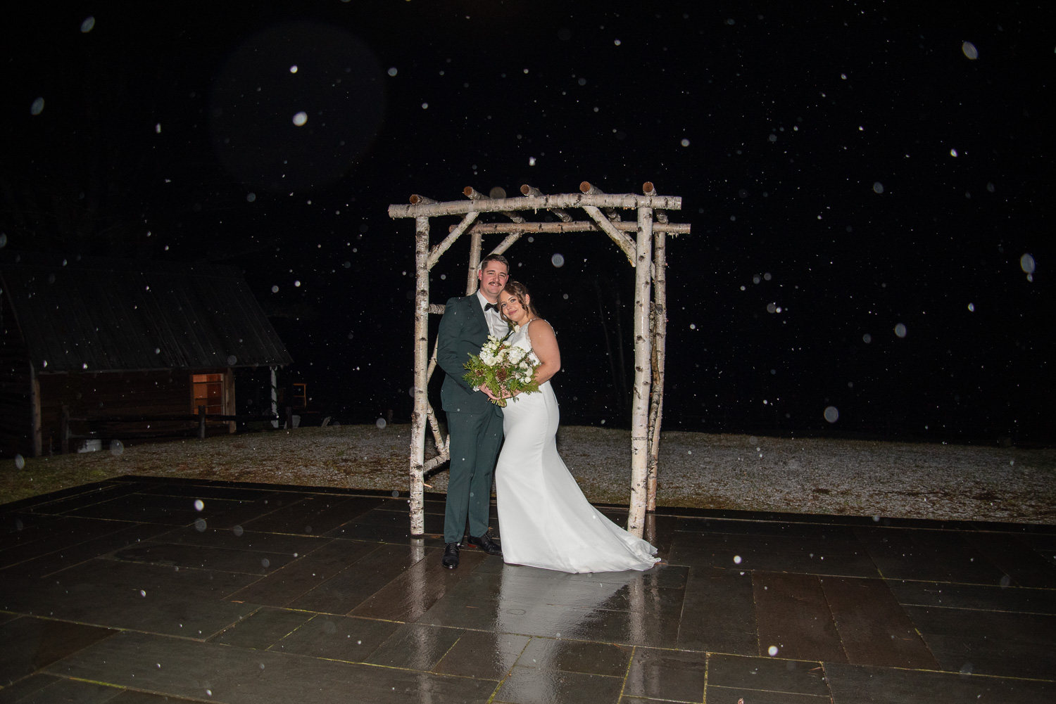 The bride and groom under the altar at the winter wonderland wedding