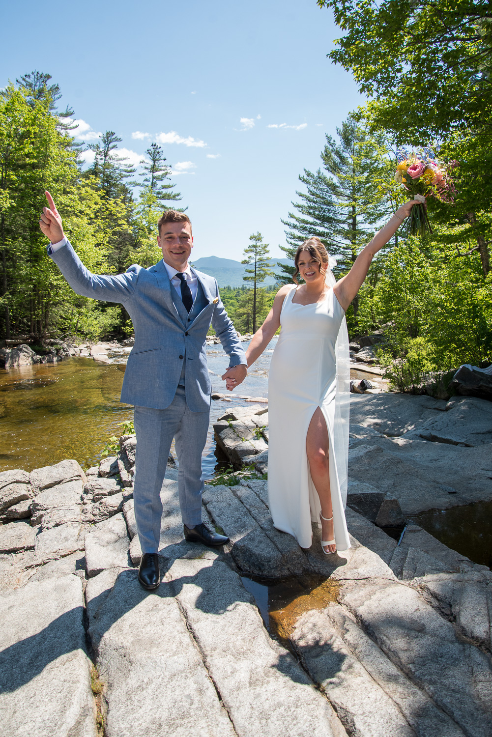 bride and groom posed at Jackson Falls in Jackson, NH before their happily ever after wedding day